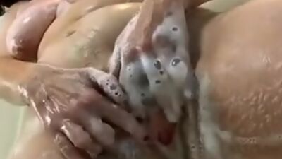 Mature woman is taking shower