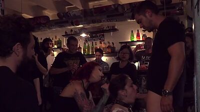 Gagged public slut sucks and cockrides in corwded bar