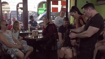 Publicly humiliated sub sucking cock with voyeurs watching