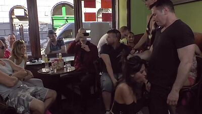 Publicly humiliated sub sucking cock with voyeurs watching