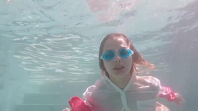 Skinny blonde ukrainian teen Clarise reveals her small tits in the pool