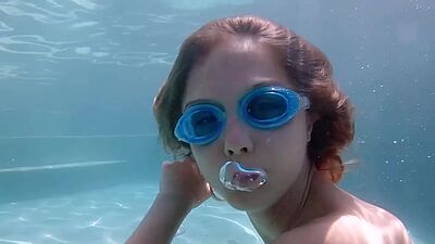 Skinny blonde ukrainian teen Clarise reveals her small tits in the pool