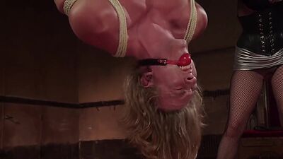 Man in invered suspension ass caned