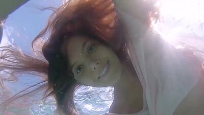 Petite Russian beauty Katya Clover showing her shaved pussy under the water