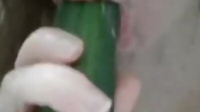 Having fun with a cucumber in the shower