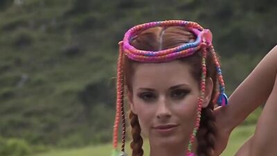 Big boobed naked blondie Danielle Mathers posing on a horse outdoor