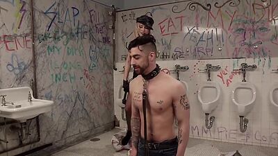 Femdom whipping man in public toilet