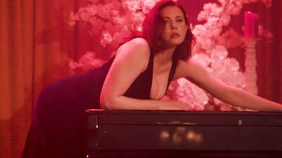 Amazing big boobs MILF Maitland Ward posing on the piano and striptease