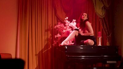 Amazing big boobs MILF Maitland Ward posing on the piano and striptease