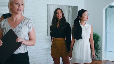 Lesbian couple Avery Black and April Olsen testing the bed in an open house