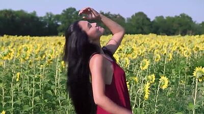 Cute small tits Asian teen Kimiko posing in sunfolower field in red dress