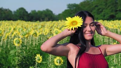 Cute small tits Asian teen Kimiko posing in sunfolower field in red dress