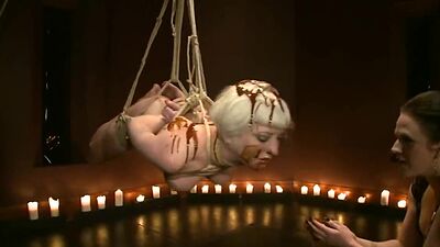 Bound slave spreaded with chocolate
