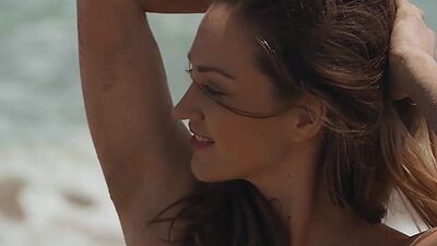 Beautiful teen model posing on the beach and showing stunning natural body