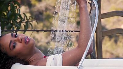 All natural ebony babe Scarlit Scandal stripping a taking a bath outdoor