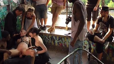 Bald slut in leather harness 3way DP fucked in public