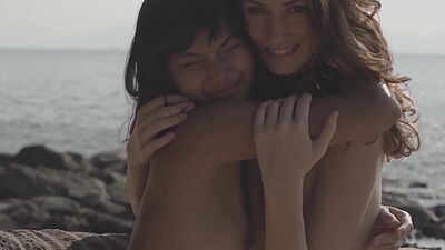 Skinny naked lesbians Cara Pin and Mikaela McKenna posing on the rocks