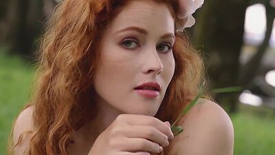 Redhead Latvian babe Heidi Romanova reveals her big natural tits outdoor