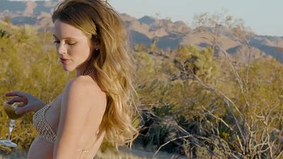 Big natural tits MILF blonde Ora Young gives a striptease in the desert