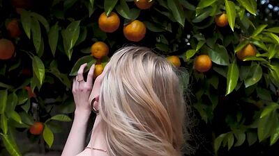 Cute blonde teen model posed in the park and exposed her beautiful tits