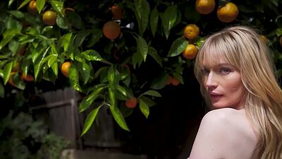 Cute blonde teen model posed in the park and exposed her beautiful tits