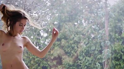 Petite naked Ukrainian beauty Diana Lark teasing and posing by the window