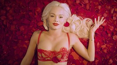 Amazing blonde pornstar Elsa Jean posing naked in a bed of roses