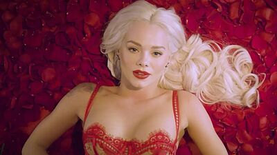 Amazing blonde pornstar Elsa Jean posing naked in a bed of roses