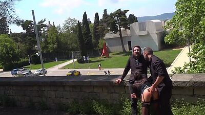 Public babe deepthroating outdoor while spanked in 3some