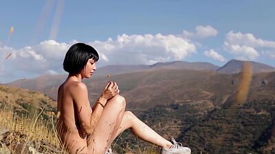 Skinny brunette muse Sophia introducing her small tits on a hilltop outdoor