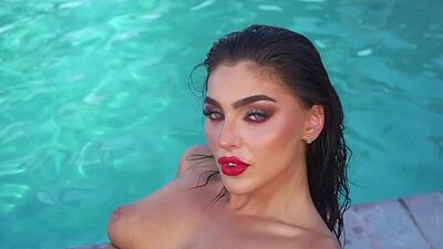 Gorgeous brunette MILF babe Emjay Rinaudo solo striptease in the pool