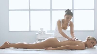 Lesbian oiled babe pussyfingered by GF on massage table