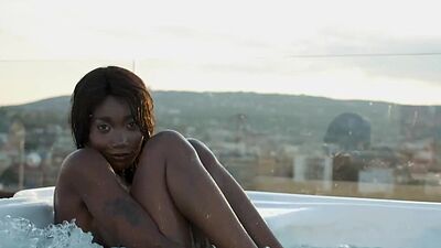 Ebony beauty from Cameroon Mimi Desuka gets naked in a pool for Playboy