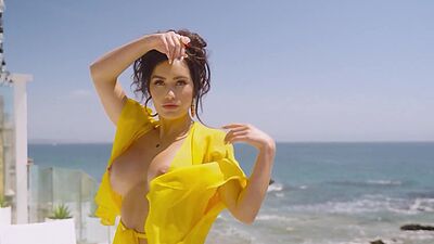 Barely clothed MILF CJ Sparxx reveals her massive boobs at her balcony