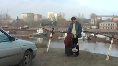 Redhead student sucks on the banks of the river for all to see