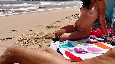 Busty redhead masturbates me on the nudist beach