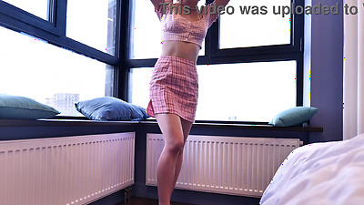 This playfull blonde masturbates by the window, inviting the curious eyes of neighbors to observe