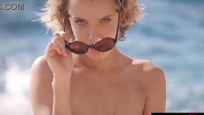 Blonde Russian MILF Oksana Chucha reveals her perfect boobs at the beach