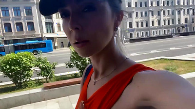 Flashing her tits on a public balcony.