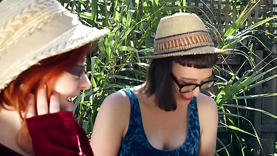 Hirsute lesbians pleasure each other orally in the garden