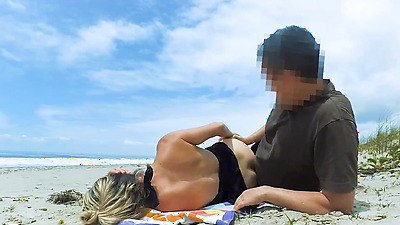 Filming an anal scene on the beach in front of passersby