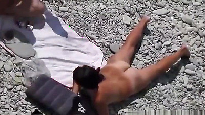 Black hair nudist and her man at beach