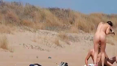 Sol fucks a guy in a beach surrounded by voyeurs