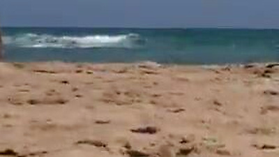 Sol fucks a guy in a beach surrounded by voyeurs