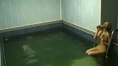 Frisky chick rubbing pussy in the pool!