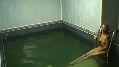 Frisky chick rubbing pussy in the pool!