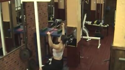 Sexy brunette stripping in the gym!
