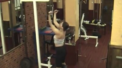 Sexy brunette stripping in the gym!