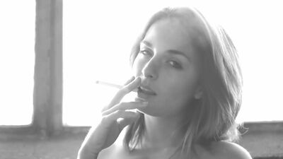 Busty Ashlee Graham smokes while showing off her natural tits