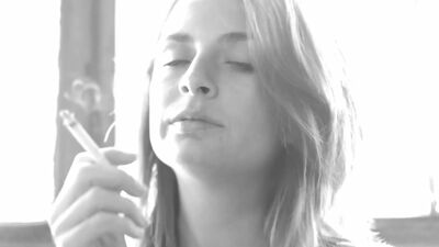 Busty Ashlee Graham smokes while showing off her natural tits